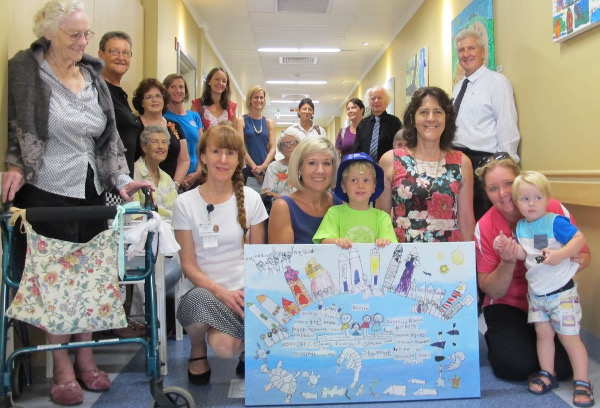 Bringing the corridor alive… patients at the Ballina District Hospital rehabilitation unit joined hospital staff, including Diversional Therapist Tracey Beck, teacher Nikki Daley and Connor Hardy, Dr Sue Page, and hospital Executive Officer Peter Jeffree.