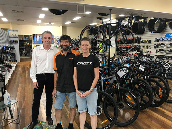 Federal MP for Page, Kevin Hogan and owners Darryl Pursey and Joanna Bonaccorsi at their South Lismore business Harris Cycles. 